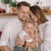 A joyful family of three embracing in a cozy kitchen. Warm and loving atmosphere.